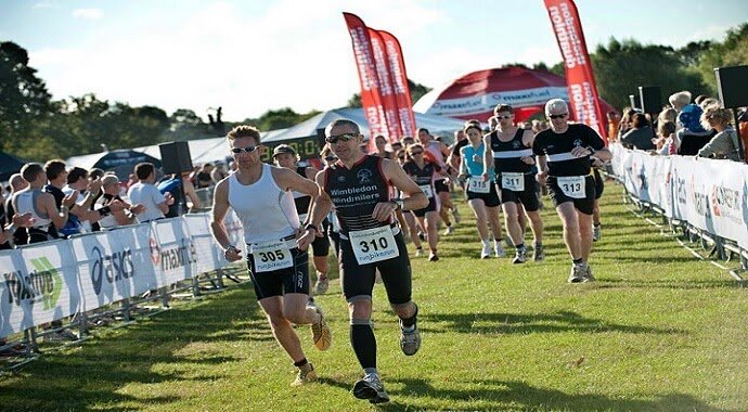 People running and cycling in a duathlon event