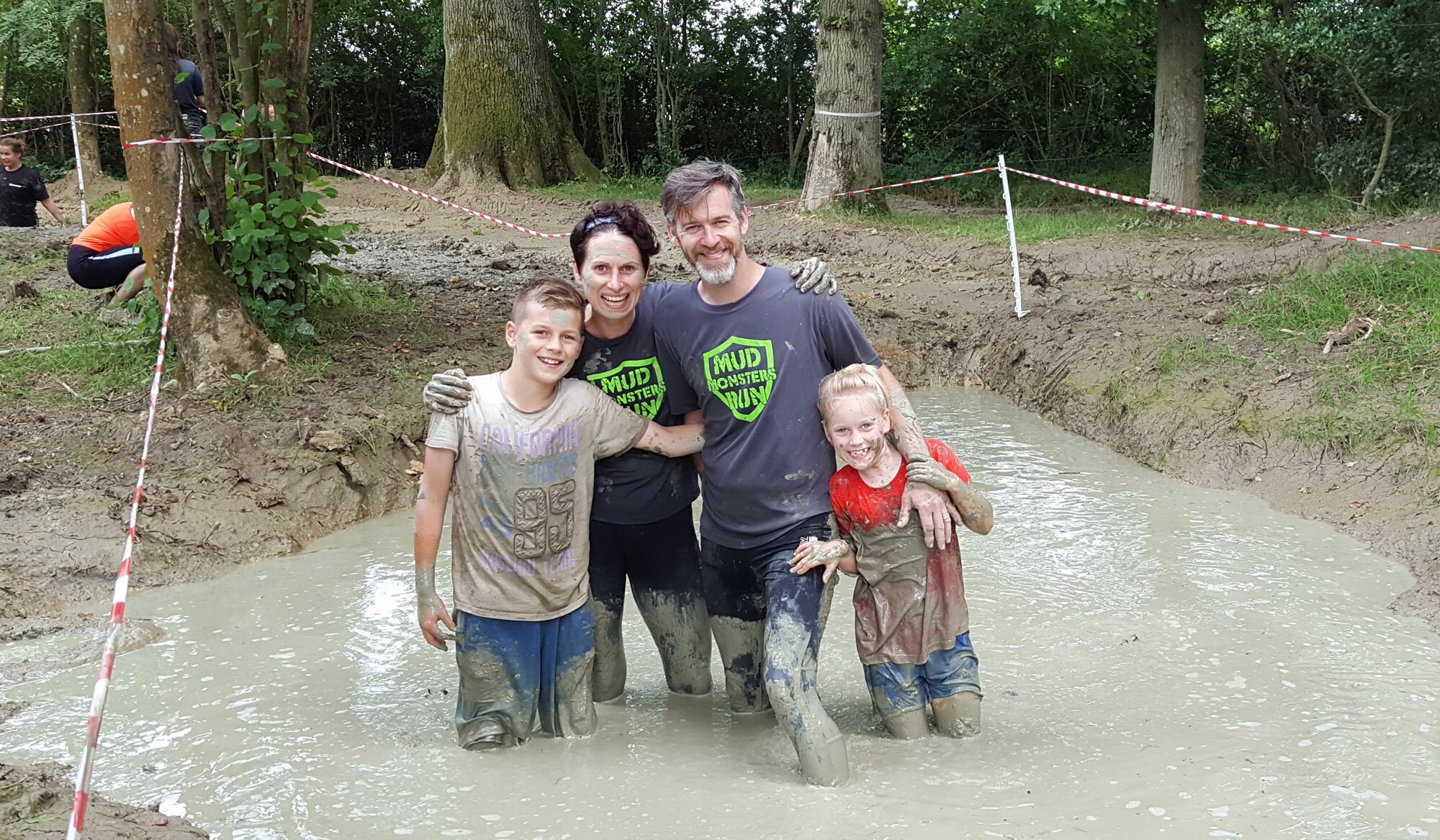 A family taking part in the Muddy Runs Mud Monsters Family Fun Run