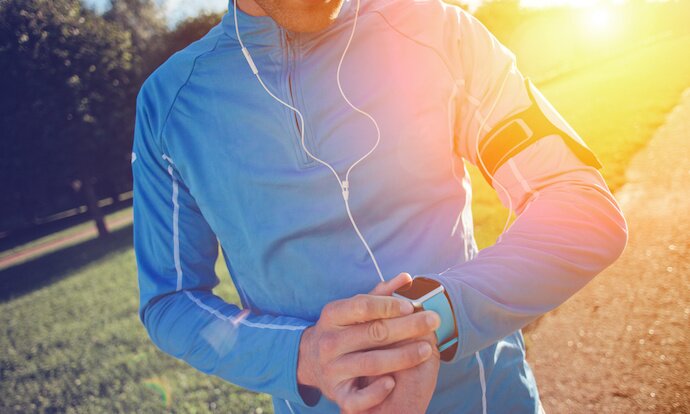 Runner timing a 5k run
